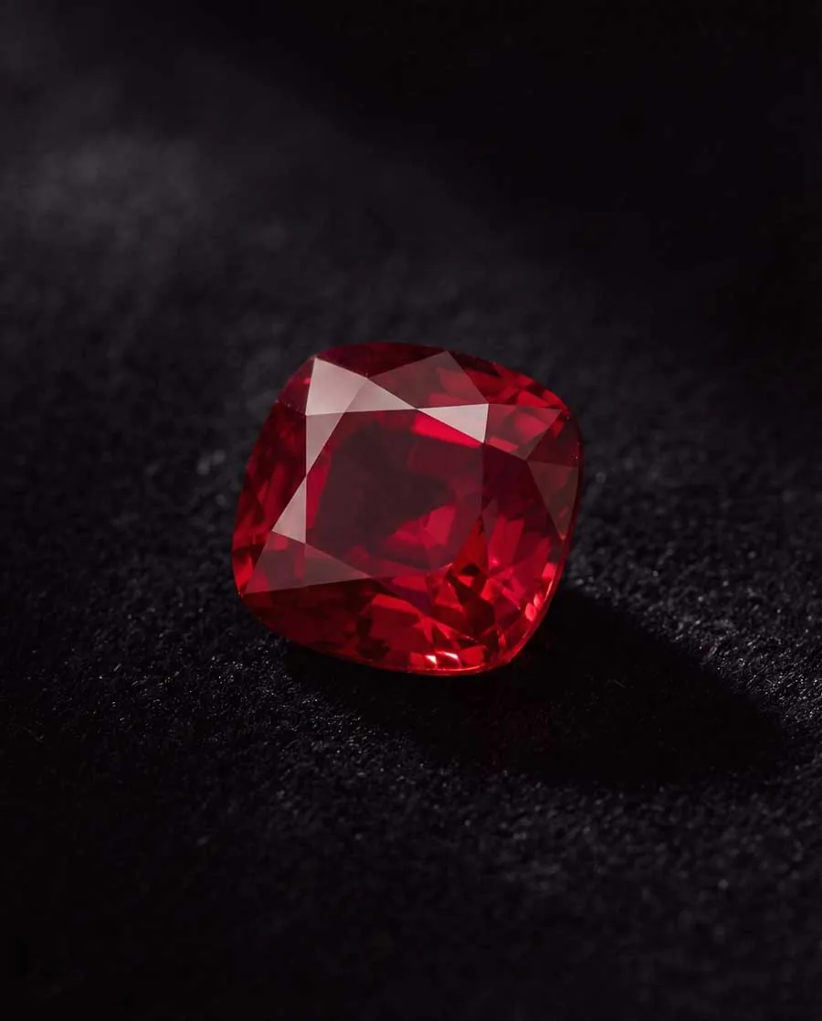 Close-up of deep red Burmese pigeon blood ruby gemstone showcasing July birthstone's vivid red color with slight blue undertones